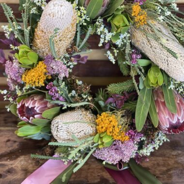 Beautiful wildflower wreath featuring an array of Australian native blooms such as Banksia, Protea, and Eucalyptus, arranged in a natural, rustic design perfect for memorial service